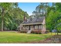 Charming home featuring a welcoming front porch, white-framed windows, and a well-maintained lawn at 5317 Black Oak Ln # 11, Waxhaw, NC 28173