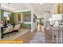 Elegant dining room with stylish chandelier, seating for six, and wood floors at 5655 Arnold Way, Mount Pleasant, NC 28025