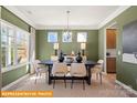 Inviting dining room featuring stylish chandelier and plentiful sunshine at 5655 Arnold Way, Mount Pleasant, NC 28025