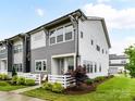 Attractive two-story gray townhome with well-manicured lawn and white picket fence at 5811 Mantle Way, Kannapolis, NC 28081