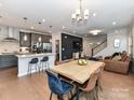 Open-concept living space featuring a dining area, modern kitchen, and cozy seating at 5811 Mantle Way, Kannapolis, NC 28081