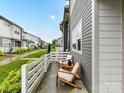 Inviting patio with white chairs and landscaping offers a relaxing outdoor space at 5811 Mantle Way, Kannapolis, NC 28081
