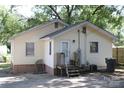 Backyard view of a yellow home with a small porch and concrete area at 606 E 4Th Ave, Gastonia, NC 28054
