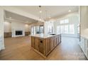 Open-concept kitchen showcasing a large center island, modern appliances, and hardwood flooring at 608 Deodar Cedar Dr # 69, Matthews, NC 28104