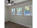 Cozy bedroom with hardwood floors, white trim, and multiple windows with natural light at 631 Chipley Ave, Charlotte, NC 28205