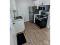 Modern kitchen with stainless steel appliances, marble countertops, and white cabinets at 631 Chipley Ave, Charlotte, NC 28205