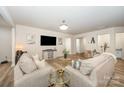Bright living room with neutral tones, plush sofas, decorative accents, and wood-look flooring at 705 Hinterland Ln, Matthews, NC 28104