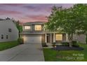 Well-maintained two-story home featuring stone accents, manicured lawn, and an attached two-car garage at 7101 Agnew Dr, Charlotte, NC 28273
