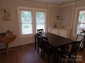 Dining room featuring dark wood furnishings, bright windows, and ample space at 804 Dennis St, Troy, NC 27371
