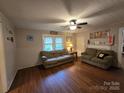 Cozy living room with neutral colored walls, two sofas, and a ceiling fan at 804 Dennis St, Troy, NC 27371