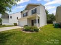 Attractive two-story home featuring a two-car garage, well-kept landscaping, and sidewalk at 8314 Paw Valley Ln, Charlotte, NC 28214