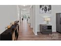 Hallway with wood-look floors and neutral wall paint at 9110 Buckley Ct # 154, Charlotte, NC 28269