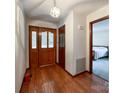 Inviting foyer with hardwood floors, wood door with glass, and access to a bedroom at 965 Hunting Ave, Lincolnton, NC 28092