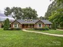 Inviting brick home with a charming walkway, well-kept landscaping, and lovely curb appeal at 965 Hunting Ave, Lincolnton, NC 28092