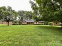 Charming single story brick home with manicured lawn and mature shade trees at 965 Hunting Ave, Lincolnton, NC 28092