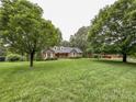 Lovely brick home surrounded by mature trees and a large, green lawn at 965 Hunting Ave, Lincolnton, NC 28092