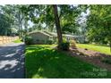 Long driveway leading to a charming single-story home with manicured landscaping at 1035 15Th Nw Ave, Hickory, NC 28601