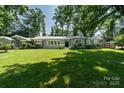 Beautifully landscaped front yard of a single-story home with mature trees at 1035 15Th Nw Ave, Hickory, NC 28601