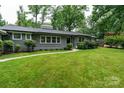 Well-manicured lawn and landscaping accentuate the exterior of this home at 1035 15Th Nw Ave, Hickory, NC 28601