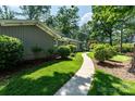 Inviting walkway leads to a beautifully maintained home with mature landscaping at 1035 15Th Nw Ave, Hickory, NC 28601