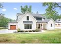 Stunning two-story home with a manicured lawn and modern farmhouse architectural details at 106 Arbor Dr, Waxhaw, NC 28173