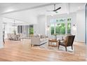 Spacious living room with an open floor plan and large windows showcasing lush greenery at 106 Arbor Dr, Waxhaw, NC 28173