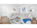 Bright living room with a large sectional sofa, modern decor, and wood flooring at 130 Slalom St, Statesville, NC 28677