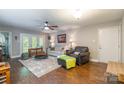 Open living room featuring hardwood floors, large windows, and comfortable seating at 1804 Fairlawn Ct, Rock Hill, SC 29732