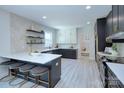 Modern kitchen featuring sleek black and white cabinets, quartz countertops, and stainless steel appliances at 2000 Plainfield Dr, Bessemer City, NC 28016