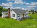 Side view of a well-kept home with green lawn and detached structure at 201 Robinson Rd, Gastonia, NC 28056