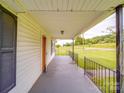 Covered front porch offering an outdoor area with green yard view at 201 Robinson Rd, Gastonia, NC 28056