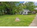 View of the expansive backyard, offering plenty of green space and mature trees at 222 W Mccubbins St, Salisbury, NC 28144