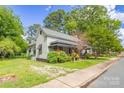 Side view of a charming home with mature trees and a well-kept lawn at 222 W Mccubbins St, Salisbury, NC 28144