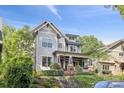 Beautiful home featuring a covered front porch, brick accents, professionally landscaped front yard, and custom stairs at 2221 Kenmore Ave, Charlotte, NC 28204