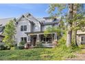 Charming home featuring a covered front porch, brick accents, and professionally landscaped front yard at 2221 Kenmore Ave, Charlotte, NC 28204