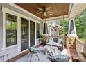 Inviting front porch with a swing, ceiling fan, comfortable seating, and stylish decor at 2221 Kenmore Ave, Charlotte, NC 28204