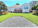 View of the backyard with a wooden deck, green grass, wood fence, and space for entertaining or relaxing at 2226 Elendil Ln, Charlotte, NC 28269