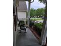 Inviting front porch with rocking chair, iron railing, and a view of the neighborhood at 2226 Elendil Ln, Charlotte, NC 28269