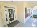 A covered front porch features a storm door entry, cream siding and red shutters at 2226 Elendil Ln, Charlotte, NC 28269