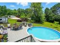 Outdoor swimming pool with surrounding deck and backyard dining set at 231 Valley View Dr, Clover, SC 29710