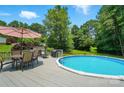 Backyard pool with patio set and wooded surround at 231 Valley View Dr, Clover, SC 29710
