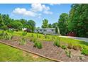 Suburban home nestled among mature trees with landscaping on a sunny day at 231 Valley View Dr, Clover, SC 29710