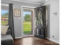 Inviting home foyer with hardwood floors, modern gray walls, and a view of the lush green front yard at 2451 Robert H Kirk Rd, Lancaster, SC 29720