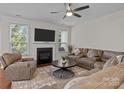 Inviting living room with a cozy fireplace, comfortable seating, and ample natural light at 308 Planters Way, Mount Holly, NC 28120