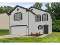 Charming two-story home with a white exterior, black accents, and freshly landscaped front yard at 3124 Pikes Peak Dr, Gastonia, NC 28052