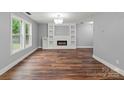 Spacious living area with hardwood floors, fireplace and natural light, creating a welcoming atmosphere at 3124 Pikes Peak Dr, Gastonia, NC 28052