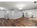 Bright, open-concept space showcasing hardwood floors and a modern kitchen with stainless steel appliances at 3124 Pikes Peak Dr, Gastonia, NC 28052