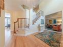 Spacious foyer featuring hardwood floors, staircase, and ample natural light at 3318 Providence Hills Dr, Matthews, NC 28105