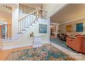 Inviting foyer with staircase, hardwood floors, and view into the living room at 3318 Providence Hills Dr, Matthews, NC 28105