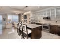 Bright kitchen boasts an island with bar seating, stainless appliances, and a view into the living area at 333 W Trade St # 1304, Charlotte, NC 28202